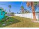 Spacious backyard with grassy area and white fence at 2010 E Vina Del Mar Blvd, St Pete Beach, FL 33706