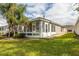 Home exterior showcasing a sunroom and well-manicured lawn at 2839 Torrance Dr, Land O Lakes, FL 34638