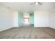 Living room with neutral walls and carpeting, view into dining area at 332 Club Manor Dr # 10, Sun City Center, FL 33573