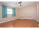 Spacious bedroom with light brown laminate flooring and teal curtains at 332 Club Manor Dr # 10, Sun City Center, FL 33573