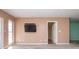 Living room with wall-mounted TV and access to hall at 332 Club Manor Dr # 10, Sun City Center, FL 33573