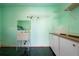 Laundry room with sink, cabinets and shelving at 332 Club Manor Dr # 10, Sun City Center, FL 33573