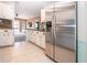 Stainless steel refrigerator in a galley kitchen with white cabinets at 332 Club Manor Dr # 10, Sun City Center, FL 33573