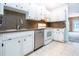 Kitchen features granite countertops, stainless steel dishwasher, and white cabinets at 332 Club Manor Dr # 10, Sun City Center, FL 33573