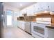Bright kitchen with granite countertops, stainless steel appliances, and white cabinets at 332 Club Manor Dr # 10, Sun City Center, FL 33573