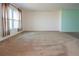 Large living room with neutral walls and carpeting, ready for your furniture at 332 Club Manor Dr # 10, Sun City Center, FL 33573