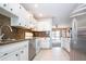Kitchen with granite countertops, stainless steel appliances, and white cabinets at 332 Club Manor Dr # 10, Sun City Center, FL 33573