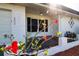 Front entrance with red flowers and a white exterior at 332 Club Manor Dr # 10, Sun City Center, FL 33573