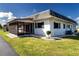 White single story home with screened porch and nicely landscaped yard at 332 Club Manor Dr # 10, Sun City Center, FL 33573