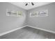 Bright bedroom with gray walls, vinyl flooring, and multiple windows at 4027 7Th S St, St Petersburg, FL 33705