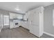 Modern white kitchen with new appliances and gray flooring at 4027 7Th S St, St Petersburg, FL 33705