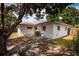 Rear of the property showing the backyard, mature trees and building architecture at 8950 3Rd N St, St Petersburg, FL 33702