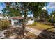 The backyard features a screened-in section and mature trees at 8950 3Rd N St, St Petersburg, FL 33702