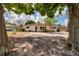 Single-story home with mature trees in the front yard at 8950 3Rd N St, St Petersburg, FL 33702