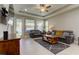 Spacious living room with gray sofas and a ceiling fan at 29167 Perilli Pl, Wesley Chapel, FL 33543