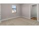 Well-lit bedroom with carpeted floors and a window at 5025 White Ave, Port Charlotte, FL 33981