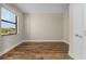 Bright bedroom with wood-look floors and large window at 5025 White Ave, Port Charlotte, FL 33981