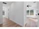 Bright hallway with hardwood floors and access to bedrooms at 1021 E 25Th Ave, Tampa, FL 33605