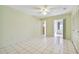 Bedroom with tile floors, ceiling fan, and access to a sunroom at 11200 102Nd Ave # 136, Seminole, FL 33778