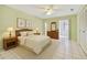Bright bedroom with white tile floors, a ceiling fan, and a sliding glass door to the porch at 11200 102Nd Ave # 136, Seminole, FL 33778