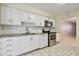 Kitchen features white cabinets, granite countertops, and stainless steel appliances at 11200 102Nd Ave # 136, Seminole, FL 33778