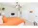 Bedroom with orange bedding and ceiling fan at 15802 Sorawater Dr, Lithia, FL 33547