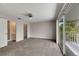 Bright bedroom with sliding glass doors to balcony, carpet, and ceiling fan at 2113 E Del Webb Blvd, Sun City Center, FL 33573