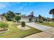 Single-story house with manicured lawn and American flag at 2113 E Del Webb Blvd, Sun City Center, FL 33573