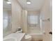 Bright bathroom with tub, shower, and updated flooring at 2113 E Del Webb Blvd, Sun City Center, FL 33573