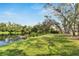 Landscaped backyard with a view of a lake at 2543 Centennial Falcon Dr, Valrico, FL 33596