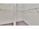 Large walk-in closet with double hanging rods and neutral carpeting at 2543 Centennial Falcon Dr, Valrico, FL 33596