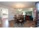 Elegant dining room with hardwood floors, a chandelier, and a large dining table at 3006 Bolt Dr, Palm Harbor, FL 34685