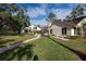 Landscaped backyard with brick pavers and patio at 3006 Bolt Dr, Palm Harbor, FL 34685