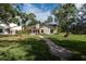 Landscaped backyard with brick pavers and patio at 3006 Bolt Dr, Palm Harbor, FL 34685