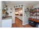 View of kitchen with white cabinets, wood floors and breakfast bar at 3006 Bolt Dr, Palm Harbor, FL 34685