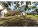 Landscaped backyard with brick pavers and patio at 3006 Bolt Dr, Palm Harbor, FL 34685