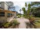 Brick paved patio with seating area and lush landscaping at 3006 Bolt Dr, Palm Harbor, FL 34685