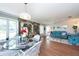 Spacious dining area with glass table and chairs, hardwood floors, and garden mural at 3006 Bolt Dr, Palm Harbor, FL 34685