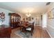 Formal dining room with hardwood floors, a chandelier and large windows at 3006 Bolt Dr, Palm Harbor, FL 34685