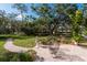 Landscaped backyard with a brick paved patio and seating at 3006 Bolt Dr, Palm Harbor, FL 34685