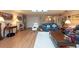 Living room with hardwood floors, comfortable seating, and a view to the kitchen at 3006 Bolt Dr, Palm Harbor, FL 34685