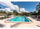Community pool with lounge chairs and a clear blue water at 3006 Bolt Dr, Palm Harbor, FL 34685