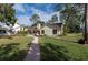 Landscaped backyard with brick pavers and patio at 3006 Bolt Dr, Palm Harbor, FL 34685