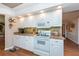 White kitchen with wood floors, and a built in microwave at 3006 Bolt Dr, Palm Harbor, FL 34685
