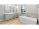 Elegant bathroom with double vanity, soaking tub, and separate shower at 4047 Southern Valley Loop, Brooksville, FL 34601