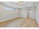 Large main bedroom with light hardwood floors and ceiling fan at 4047 Southern Valley Loop, Brooksville, FL 34601
