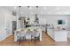 Modern kitchen with white cabinetry, large island, and stainless steel appliances at 4187 Southern Valley Loop, Brooksville, FL 34601