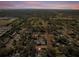 Captivating aerial shot of a home in a serene neighborhood, surrounded by lush trees and a tranquil setting at 500 53Rd S St, St Petersburg, FL 33707