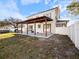 Exterior view of back of house showing spacious patio with wooden pergola and above ground pool at 500 53Rd S St, St Petersburg, FL 33707