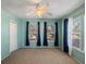 Charming bedroom with light blue walls, ceiling fan, and bright windows, creating a serene atmosphere at 500 53Rd S St, St Petersburg, FL 33707